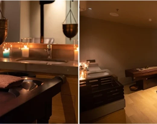 A luxury Ayurvedic therapy room featuring a dark wood Shirodhara massage table with a hanging polished brass oil pot, lit by warm candles, alongside professional Panchakarma treatment beds in a serene, dim-lit wellness sanctuary setting.